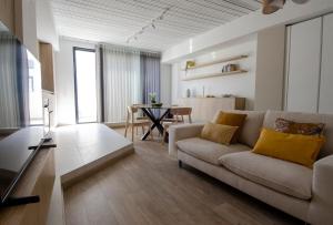 a living room with a couch and a table at Chic 2BR Apartment Steps from the Gzira Seafront in Il-Gżira