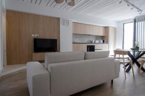 a living room with a couch and a table at Chic 2BR Apartment Steps from the Gzira Seafront in Il-Gżira