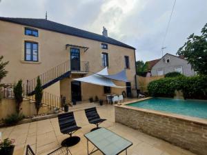 a house with a swimming pool next to a building at Pommard Clos in Pommard