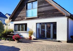 a house with a large glass door on it at Jersey Holiday Home in St Brelade