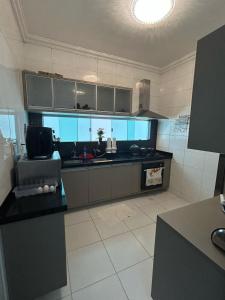 a kitchen with black counter tops in a room at Casa em condomínio próximo a COP 30 in Belém