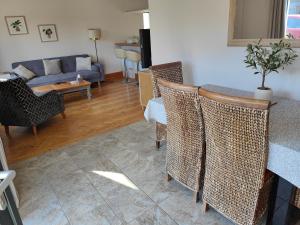 a living room with a table and chairs and a couch at Jersey Holiday Home in St Brelade