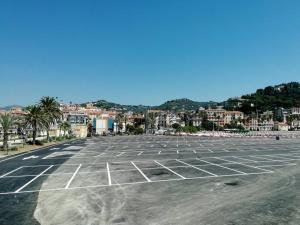 an empty parking lot with a city in the background at L'Attico sul Porto, Sea View with Terrace, Imperia Center in Imperia +13 photos