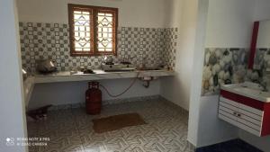 a bathroom with a sink and a window at Munnar Wood valley in Munnar