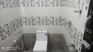 a bathroom with a toilet and a shower at Munnar Wood valley in Munnar