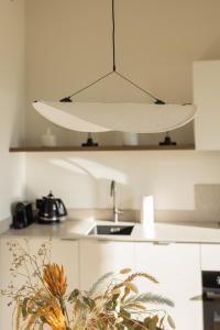 a white light hanging from a ceiling in a kitchen at Stone Suite Zakopane in Zakopane