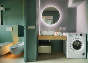 a bathroom with a sink and a washing machine at Donizetti Studios in Bergamo