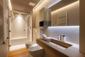 a bathroom with a white toilet and a sink at Donizetti Studios in Bergamo