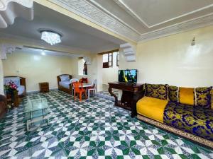a living room with a couch and a table at vintage in Fez