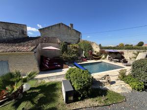 a house with a swimming pool in a yard at Maison JEROBOAM in Saint-Estèphe