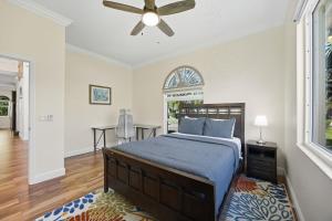 a bedroom with a bed and a ceiling fan at Plunge into Joy & Bayfront Magic at Seaside Escape - Villa Seabird in Apollo Beach +70 photos