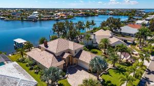 an aerial view of a house with a body of water at Plunge into Joy & Bayfront Magic at Seaside Escape - Villa Seabird in Apollo Beach