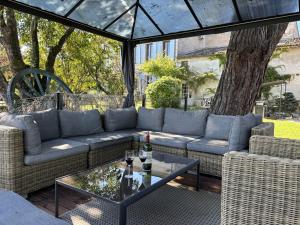 a living room with a couch and a table at Maison JEROBOAM in Saint-Estèphe