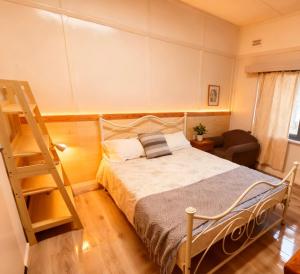 a bedroom with a bed and a ladder in it at Central Burwood Shared Stay in Sydney