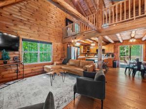 a living room with a couch and a table at Log Cabin Retreat in Monroe