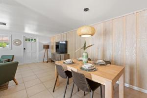 a dining room with a wooden table and chairs at Summer Lovin in Bailey Hall