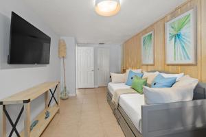 a living room with a couch and a flat screen tv at Summer Lovin in Bailey Hall