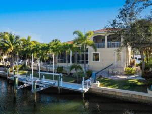 a house with a dock next to a body of water at Treasure on the Canal in Bailey Hall