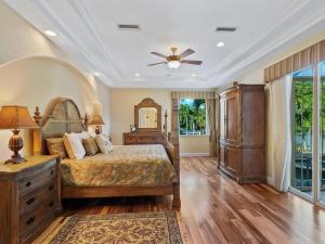 a bedroom with a bed and a ceiling fan at Treasure on the Canal in Bailey Hall +39 photos