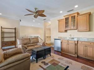 a living room with two couches and a kitchen at Treasure on the Canal in Bailey Hall