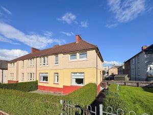 a large house with a fence in front of it at Ashgrove House - 3 bedroom in Coatbridge