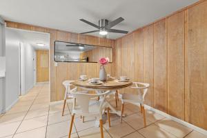a dining room with a table and chairs and a ceiling fan at Summer Nights in Bailey Hall
