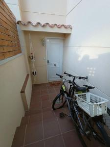 a bike parked in a room with a staircase at La Cantonada in Sant Pere de Ribes