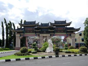 a large building with a dog statue in front of it at Heritage Vacation Inn at Jalan Padungan in Kuching