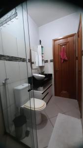 a bathroom with a toilet and a sink at Cozy Family Home - COP 30 in Belém