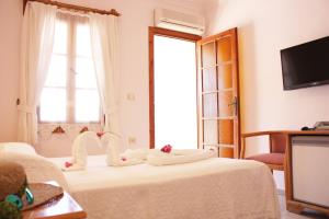 a room with a bed with towels on it at Toloman Hotel Bitez Beach in Bitez