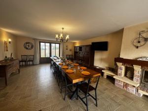 a large dining room with a long table with chairs at La maison Cécile 15/17 pers in Étais-la-Sauvin