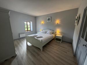 a bedroom with a bed and a window and two lamps at La maison Cécile 15/17 pers in Étais-la-Sauvin +31 photos