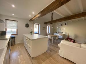 a kitchen and living room with a couch and a table at Charmant appartement centre ville de Castres in Castres