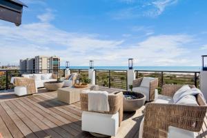 a deck with couches and chairs on a roof at Siesta Beachfront Paradise in Siesta Key