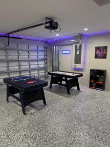 Una sala de juegos con dos mesas de ping pong. en Luxury Stay by Kathy NEW POOL, en Cabo Coral