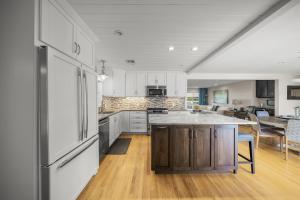 a kitchen with white cabinets and a counter top at The Shaded Sanctuary in Southgate