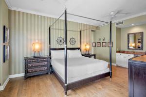 a bedroom with a four poster bed and two night stands at Penthouse Paradise in Siesta Key +51 photos