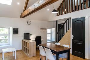 une cuisine et une salle à manger avec une table et des chaises dans l'établissement Gîte Cheval doré dans la ferme, à Ryes