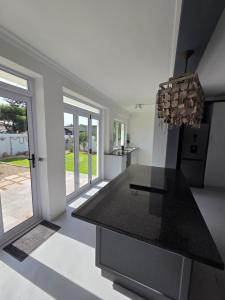 a kitchen with a black counter top in a house at Stoepstories in Yzerfontein