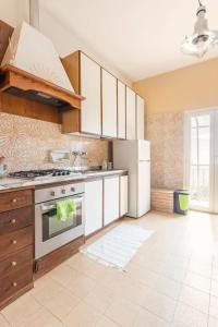 a kitchen with white cabinets and a stove at Humus Sapiens 1 in Tavarone +62 photos