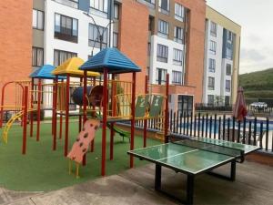 a playground with a slide and a table at Descansa en el Mejor Club Residencial de Cartago in Cartago