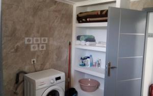 a bathroom with a washing machine in a room at Endless BLUE Lahania in Lachania