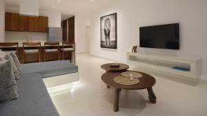 a living room with a couch and a table at One Ocean Hotel Apartments by Nest & Nomad in Msambweni