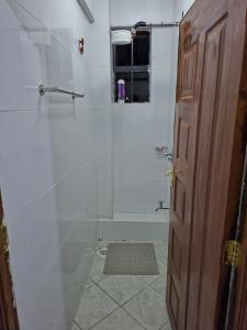 a bathroom with a shower with a glass door at Saffron Homes A6 in Eldoret