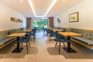 a row of tables and chairs in a restaurant at Pension Berglehner in Bad Griesbach