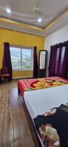 a bedroom with a large bed and a window at Golden Villa in Vagamon