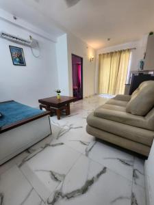 a living room with a couch and a table at Infinity Homes in Gurgaon