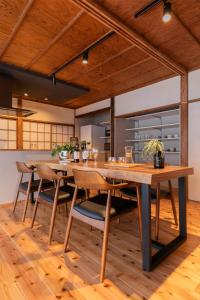 a kitchen with a large wooden table and chairs at 一棟貸し 小海の宿 いおり in Numazu +33 photos