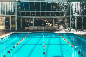 a large swimming pool with a pool at Pioneros Suites by Grupo Tierra Gaucha in San Carlos de Bariloche