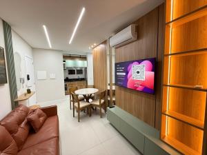 a living room with a couch and a table at Smart Home em Capão da Canoa in Capão da Canoa
